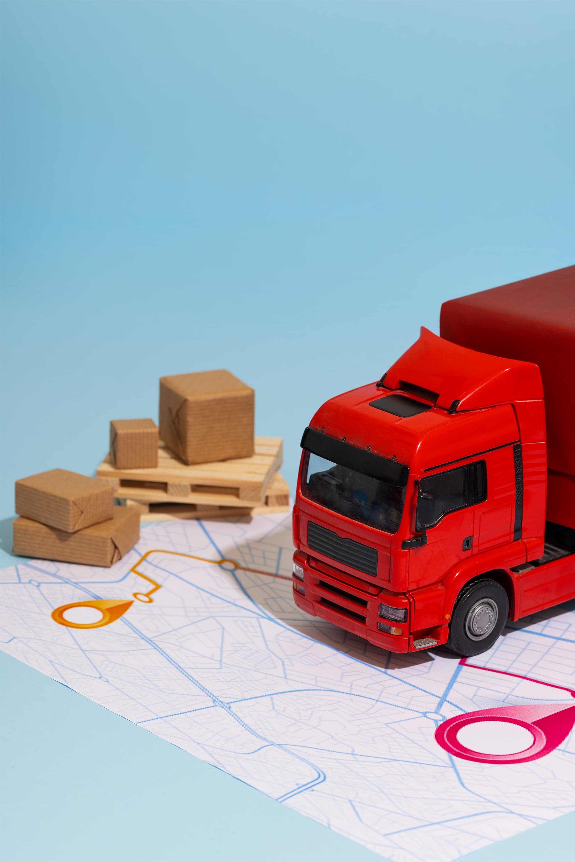 Order tracking image with red truck on top of a map and some packages.